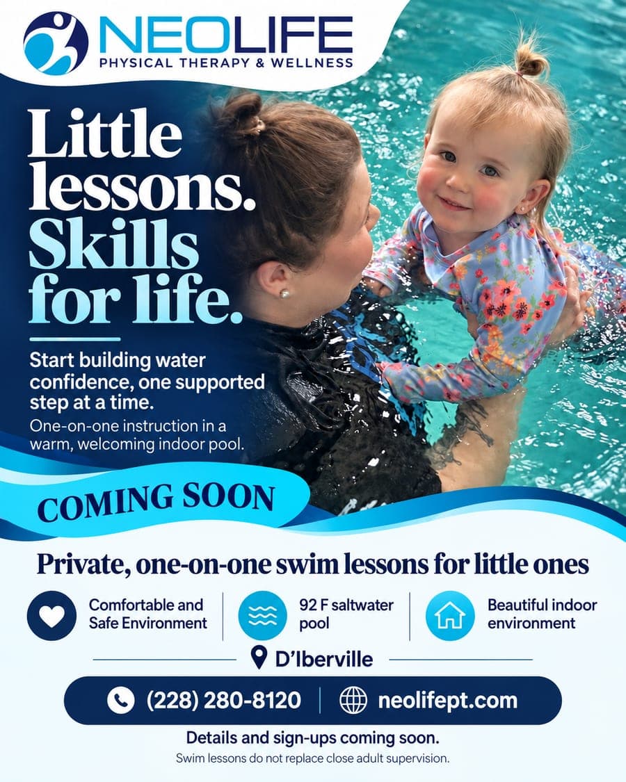 A NeoLife instructor supporting a smiling toddler in the warm indoor pool at NeoLife D'Iberville